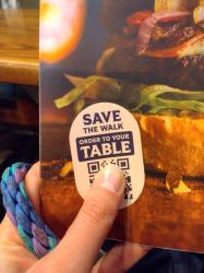 note on menu saying 'save the walk, order to your table'