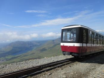 a train, nearing the top of the mountain