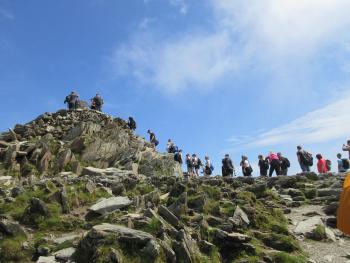 a queue of people waiting to reach the summit
