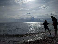 adult and child by the sea