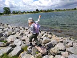 child walking on rocks by the sea