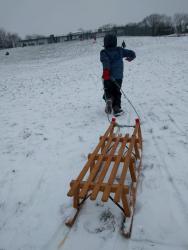 child pulling sledge