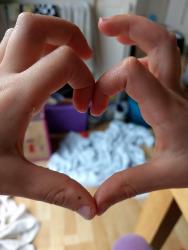 child's hands forming the shape of a heart